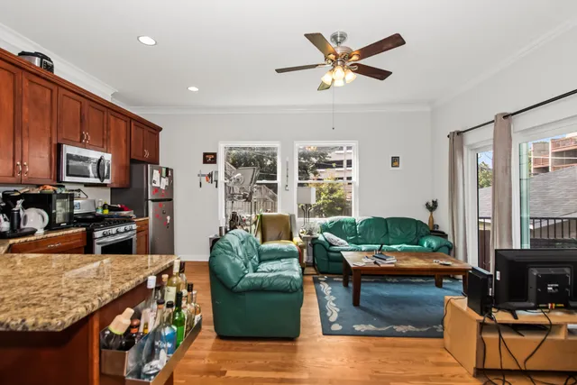 a kitchen with stainless steel appliances granite countertop a refrigerator a stove top oven a sink and dishwasher