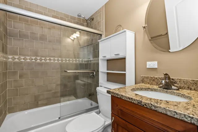 a kitchen with stainless steel appliances granite countertop a stove a sink dishwasher a refrigerator and cabinets with wooden floor