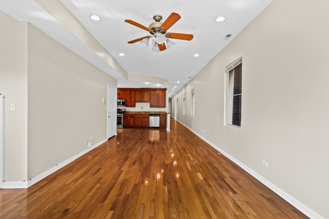 2710 North Artesian Avenue Chicago, IL 60647 - Photo 44 of 61 an empty room with wooden floor and windows