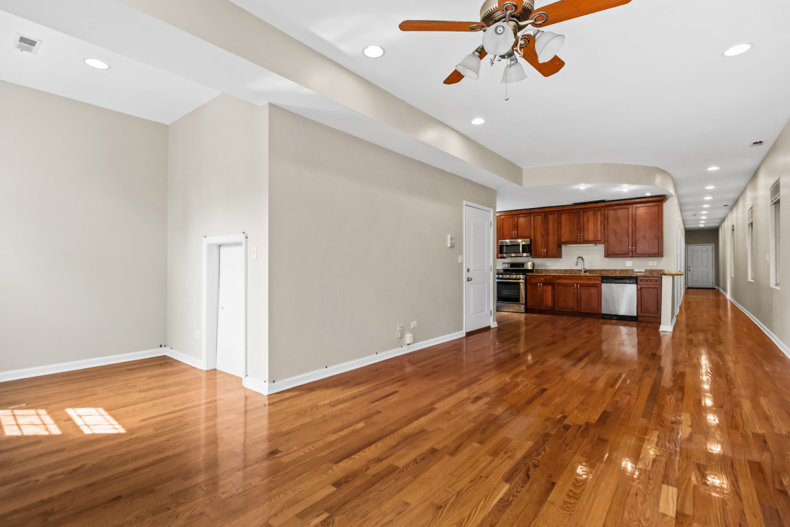 2710 North Artesian Avenue Chicago, IL 60647 - Photo 46 of 61 a view of kitchen and empty room with wooden floor