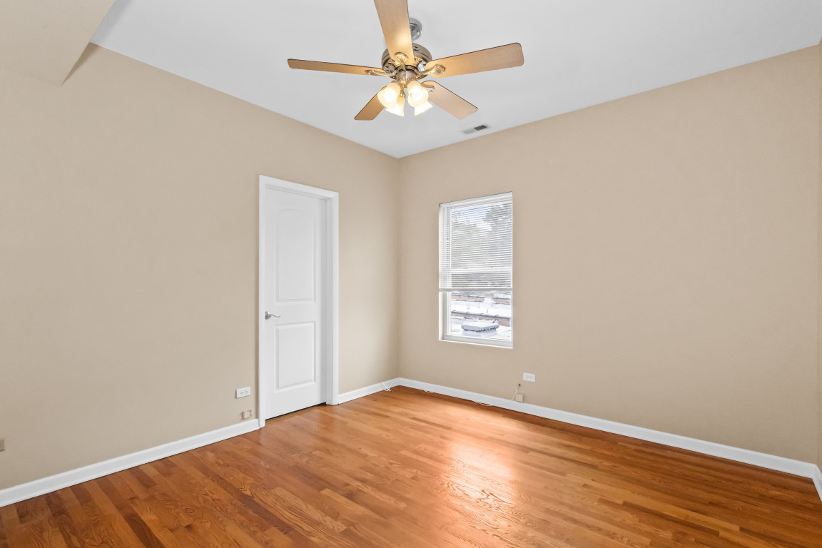 2710 North Artesian Avenue Chicago, IL 60647 - Photo 50 of 61 an empty room with a window and a ceiling fan