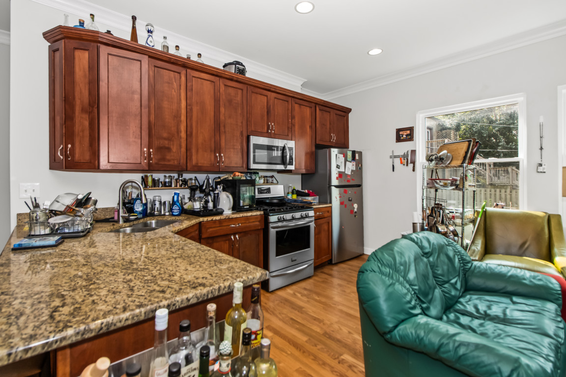 2710 North Artesian Avenue Chicago, IL 60647 - Photo 5 of 61 a kitchen with stainless steel appliances granite countertop a refrigerator a stove top oven a sink and dishwasher
