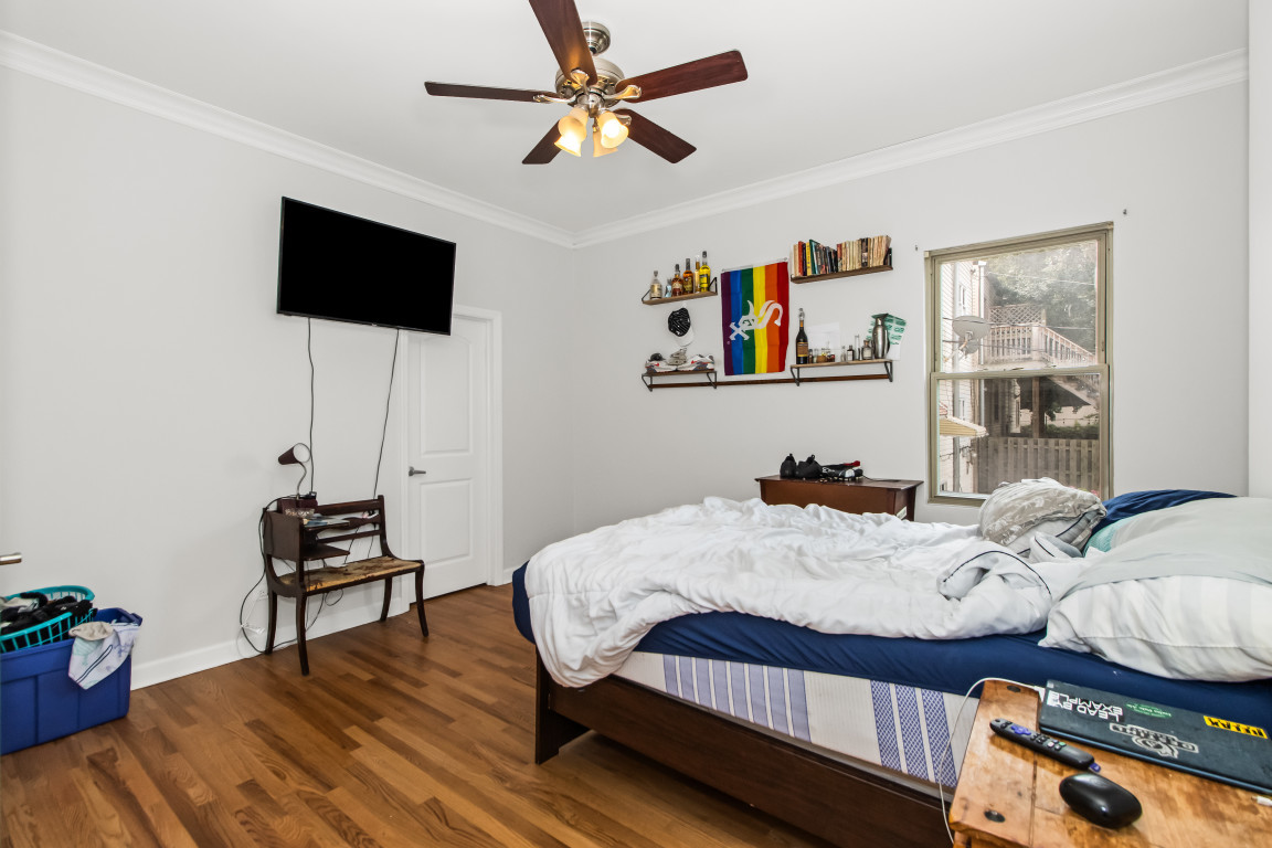 2710 North Artesian Avenue Chicago, IL 60647 - Photo 7 of 61 a bedroom with a bed and a flat screen tv