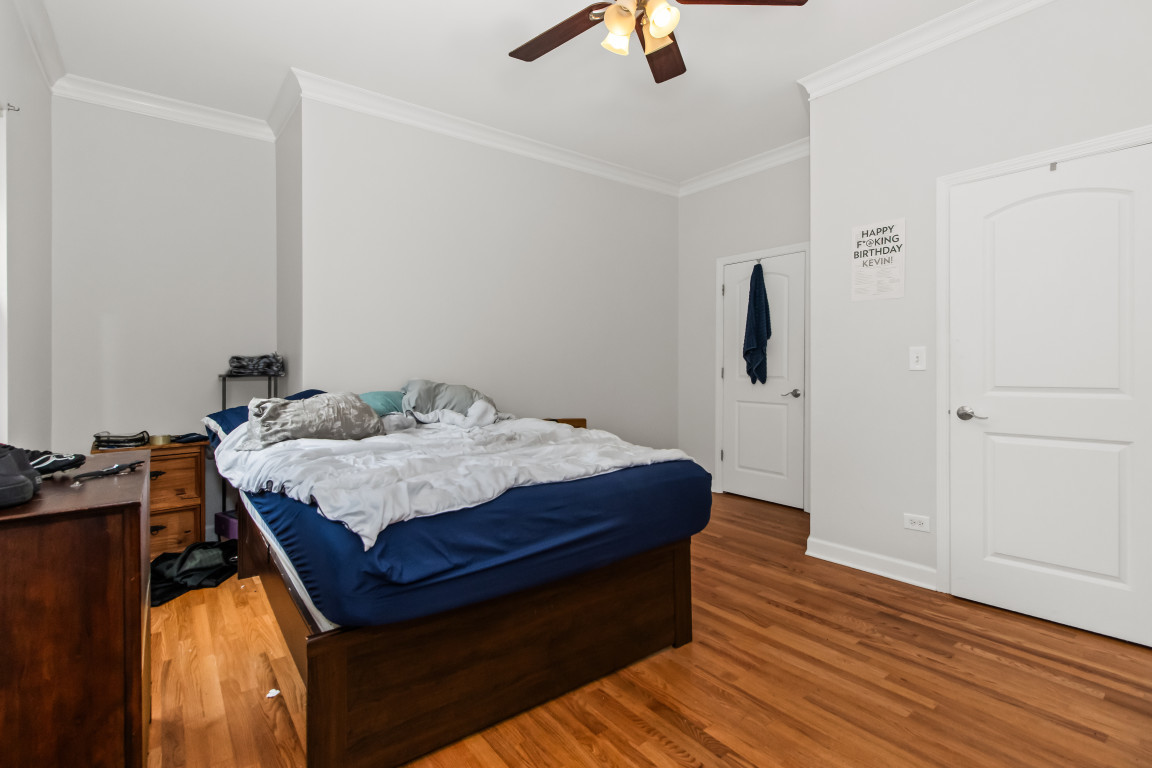 2710 North Artesian Avenue Chicago, IL 60647 - Photo 8 of 61 a bedroom with a bed and wooden floor