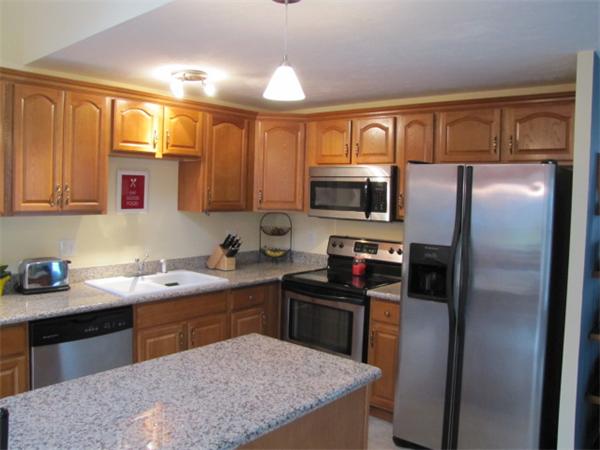 9 Pearlbush Path Worcester, MA 01607 - Photo 23 of 28 a kitchen with a sink refrigerator and microwave