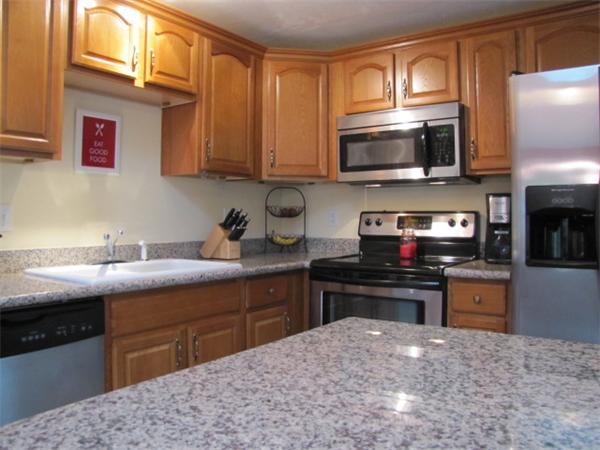 9 Pearlbush Path Worcester, MA 01607 - Photo 6 of 28 a kitchen with stainless steel appliances granite countertop a sink stove and microwave