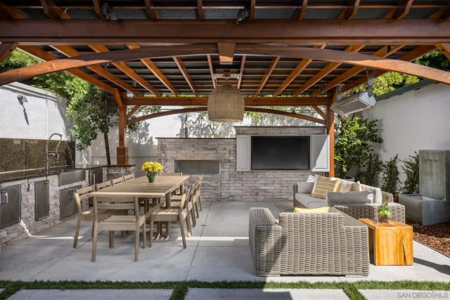 a view of a patio with table and chairs a barbeque