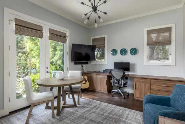 a view of a workspace with furniture and a window