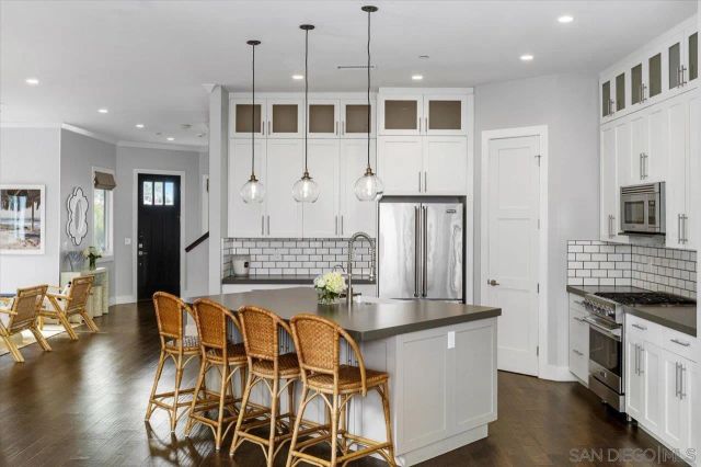 a kitchen with stainless steel appliances granite countertop a stove and a refrigerator