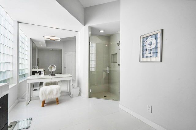 a bathroom with a double vanity sink a mirror and a bathtub