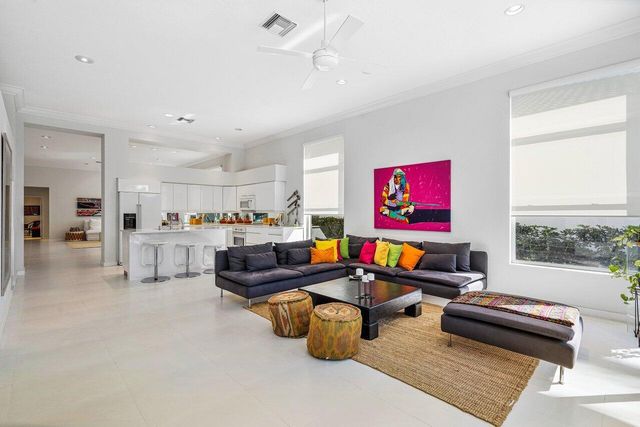 a living room with furniture and kitchen view