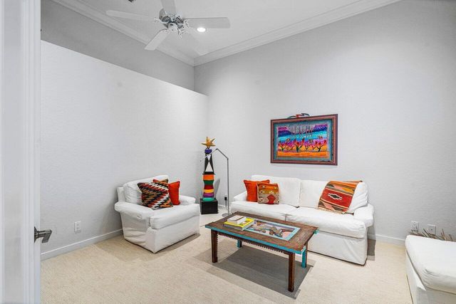 a living room with furniture and a white wall next to a white wall
