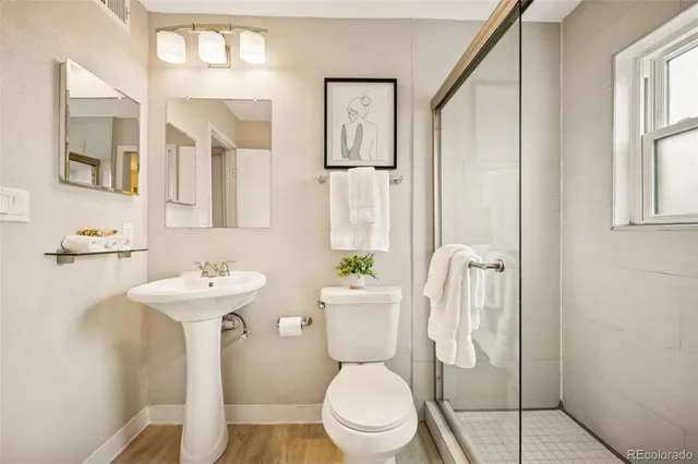 a white toilet sitting next to a bathroom sink