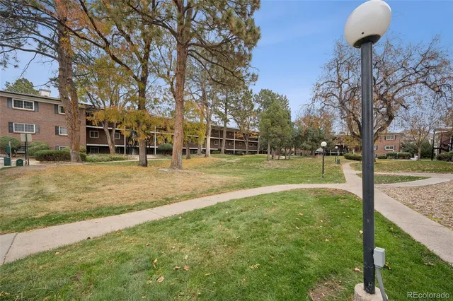 a swimming pool with trees in the background