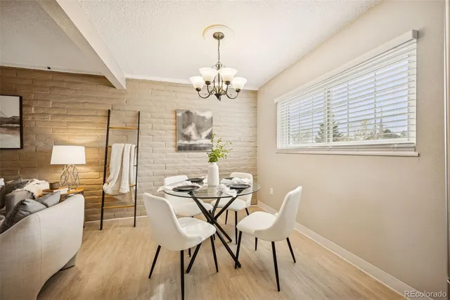 a view of a dining room with furniture wooden floor and a chandelier