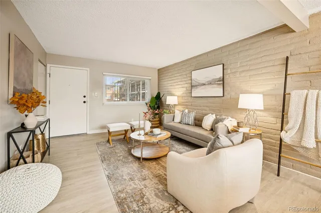 a living room with furniture potted plant and a window