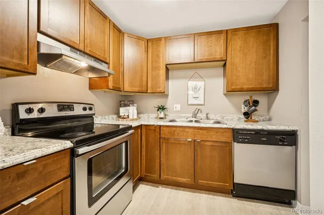 a kitchen with a sink stove and cabinets