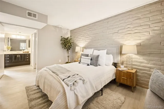 a spacious bedroom with a bed and a cabinets