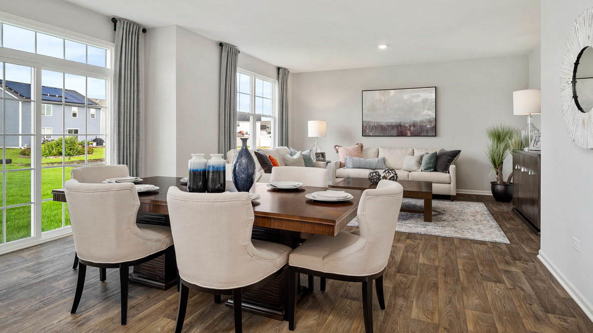 1810 Legacy Pointe Boulevard Plainfield, IL 60586 - Photo 10 of 20 a living room with furniture a large window and wooden floor