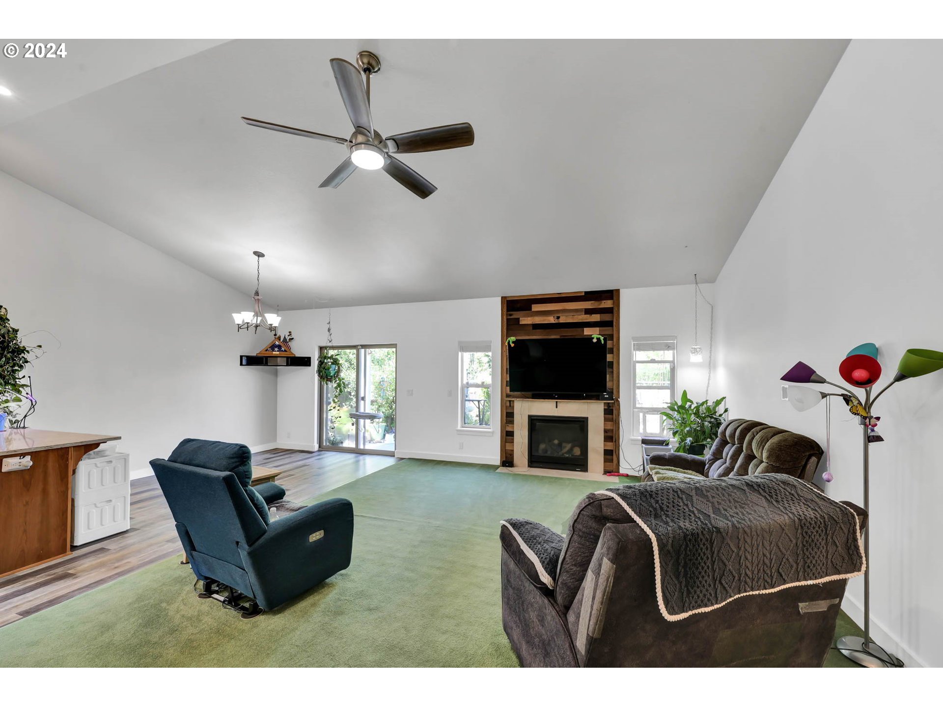 945 Pennington Court Eugene, OR 97404 - Photo 11 of 40 a living room with furniture a flat screen tv and a fireplace