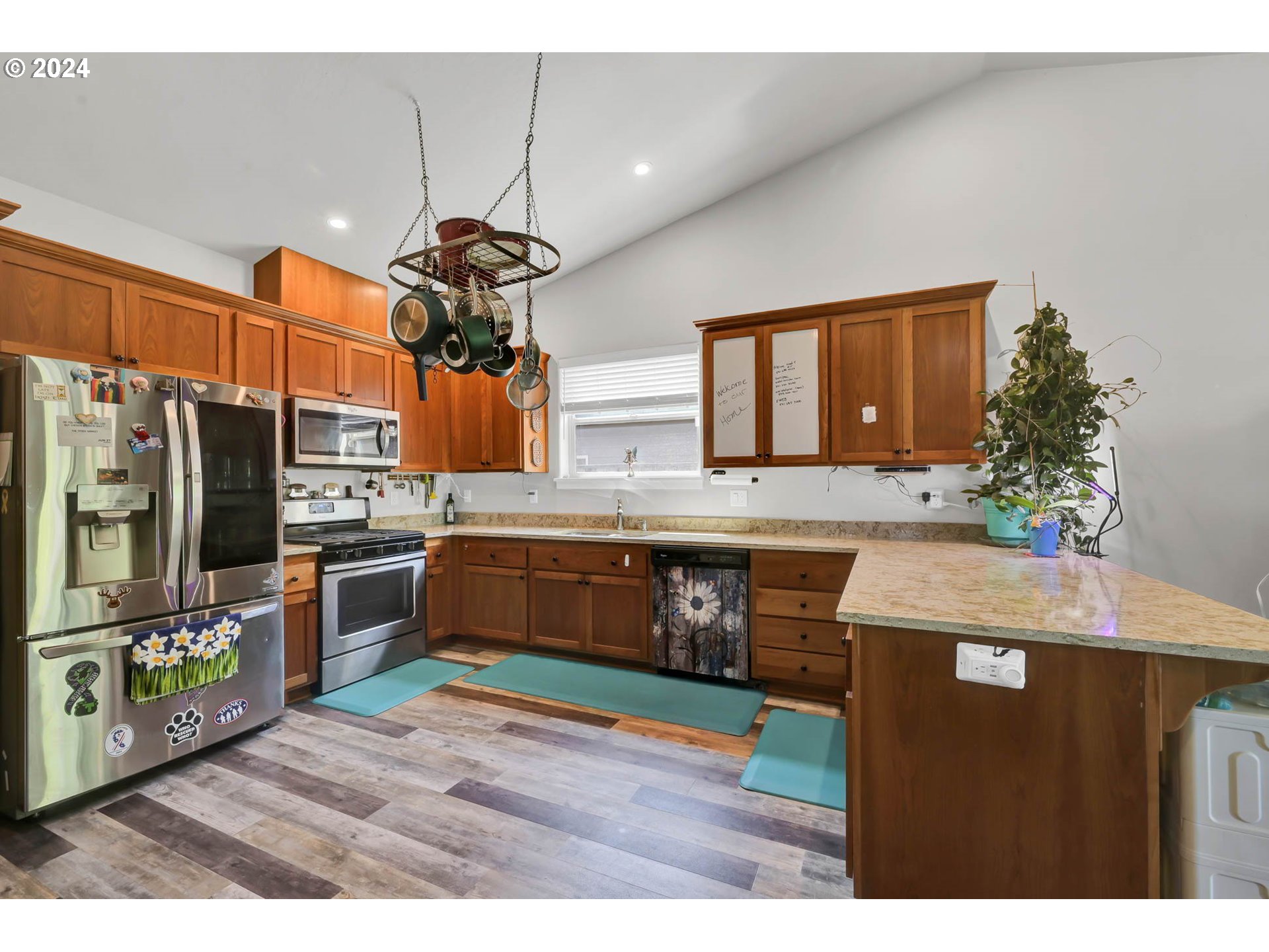 945 Pennington Court Eugene, OR 97404 - Photo 13 of 40 a kitchen with stainless steel appliances granite countertop a stove a refrigerator and a microwave