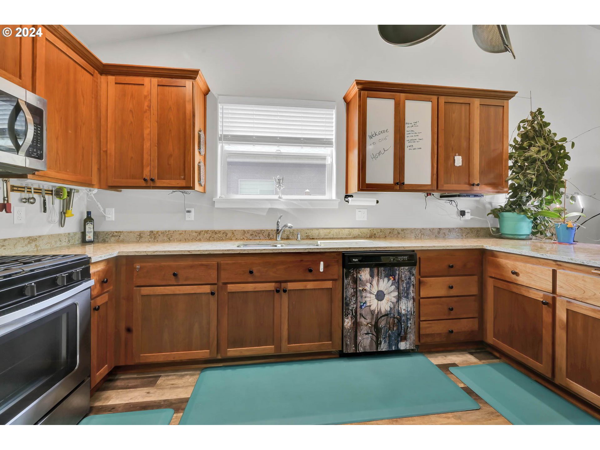 945 Pennington Court Eugene, OR 97404 - Photo 14 of 40 a kitchen with a sink cabinets and a stove