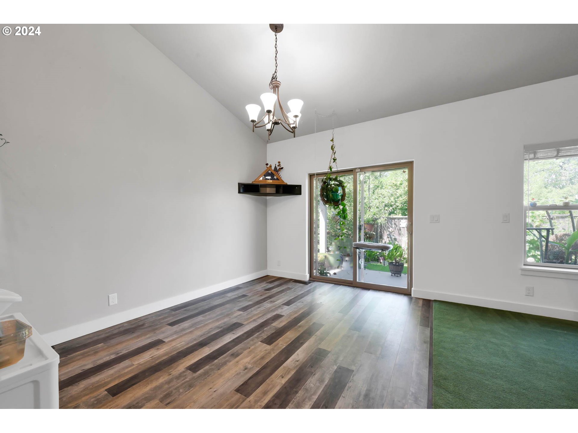 945 Pennington Court Eugene, OR 97404 - Photo 16 of 40 a view of an empty room with wooden floor and a window