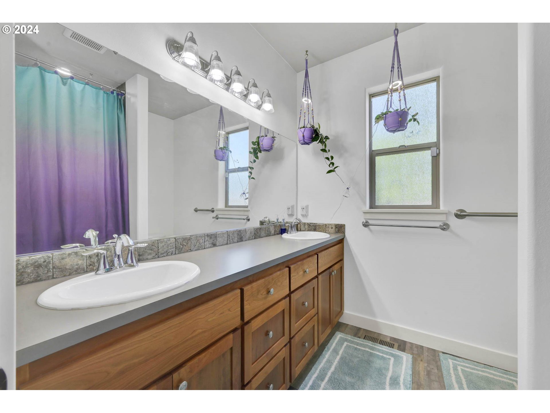 945 Pennington Court Eugene, OR 97404 - Photo 21 of 40 a bathroom with a sink double vanity granite and a mirror