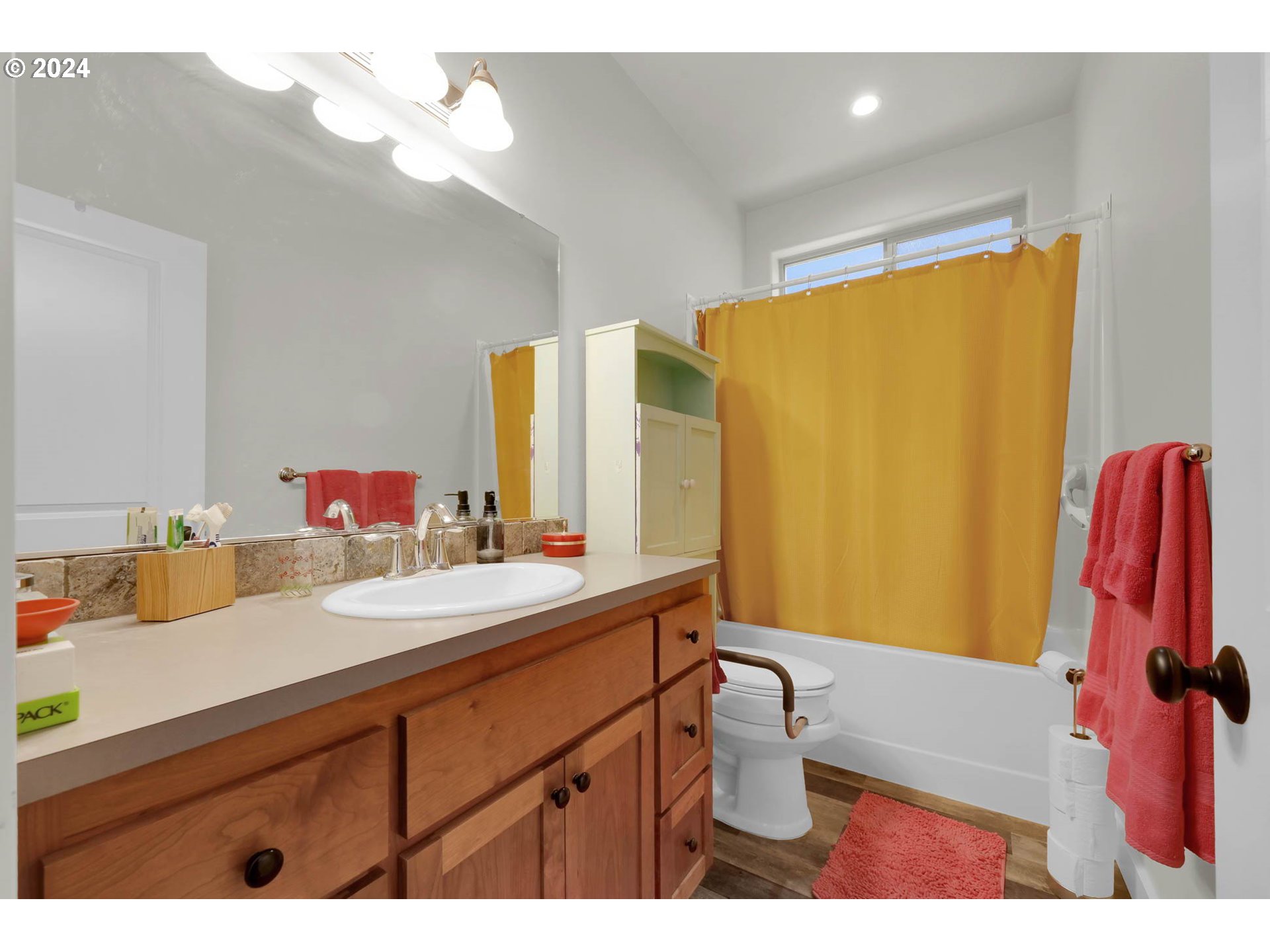 945 Pennington Court Eugene, OR 97404 - Photo 26 of 40 a bathroom with a sink a toilet and a mirror
