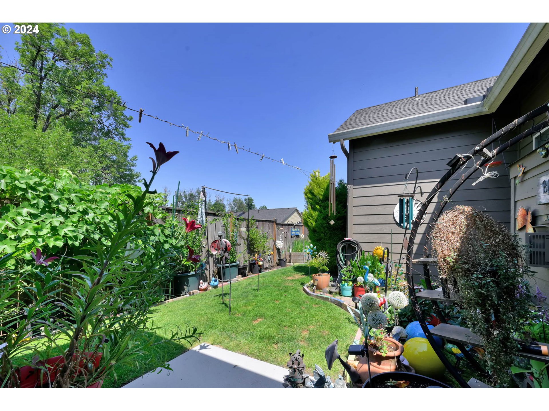 945 Pennington Court Eugene, OR 97404 - Photo 35 of 40 a view of yard with flowers and a car parked in front of it