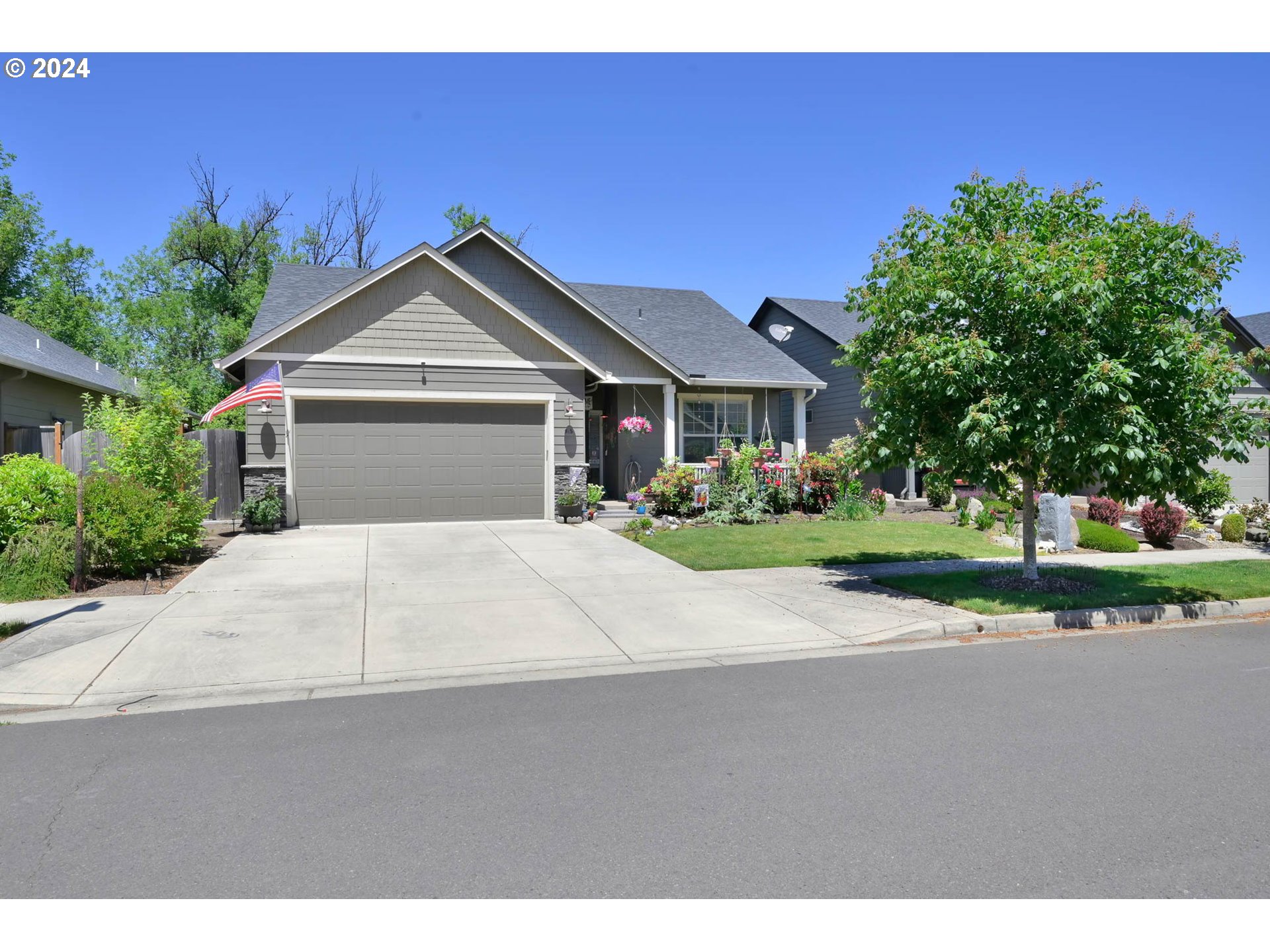 945 Pennington Court Eugene, OR 97404 - Photo 40 of 40 a white house with a big yard plants and big trees