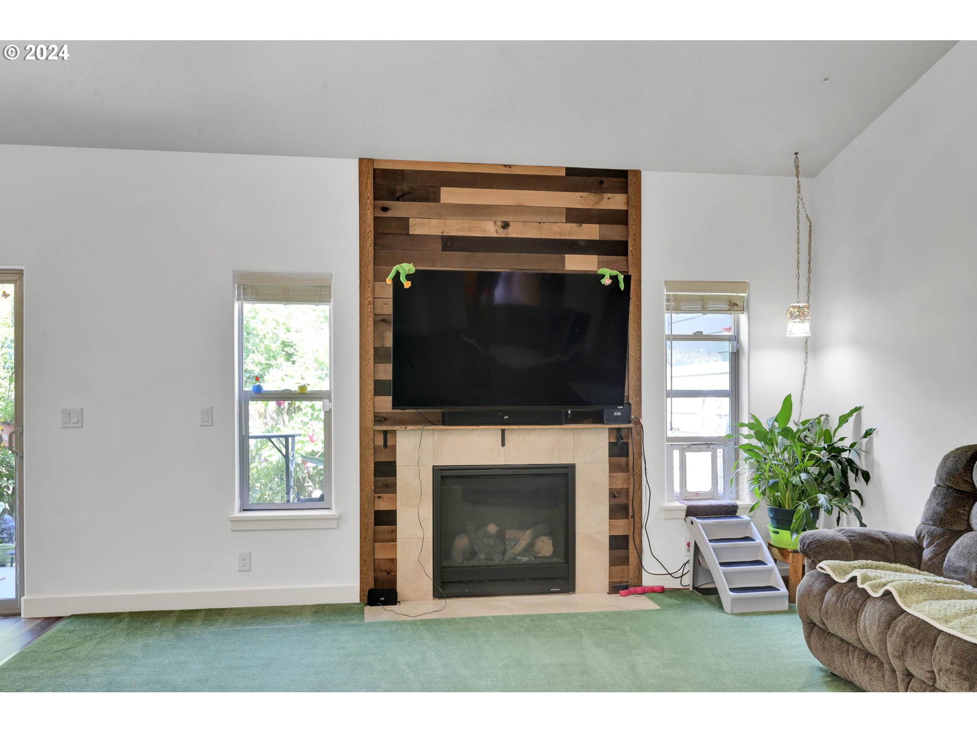 945 Pennington Court Eugene, OR 97404 - Photo 8 of 40 a living room with furniture a flat screen tv and a fireplace