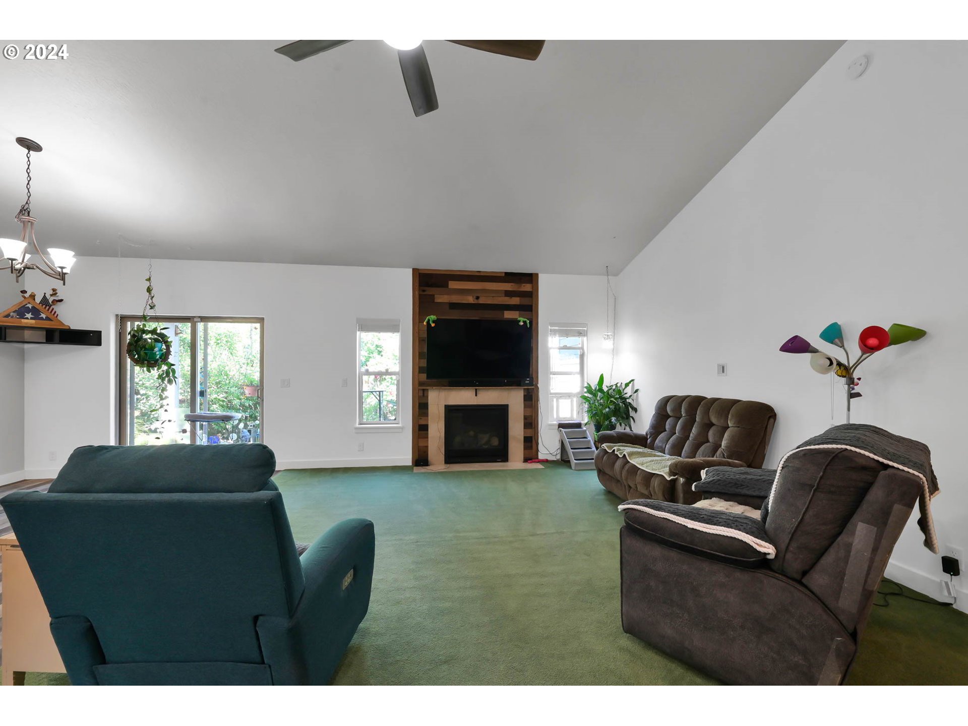 945 Pennington Court Eugene, OR 97404 - Photo 9 of 40 a living room with furniture a fireplace and a flat screen tv