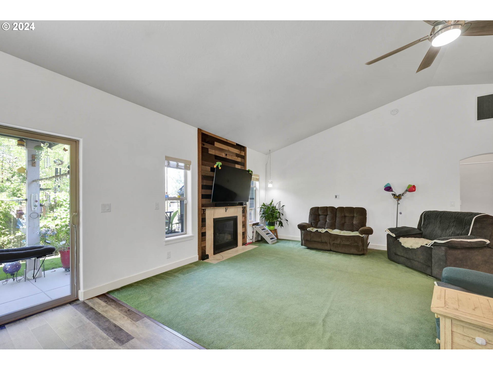 945 Pennington Court Eugene, OR 97404 - Photo 10 of 40 a living room with furniture a flat screen tv and a fireplace