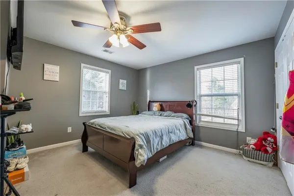 a spacious bedroom with a bed and a chandelier