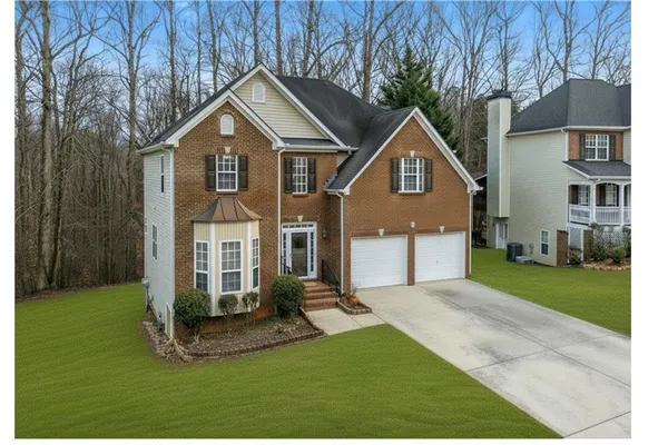 a front view of a house with a yard