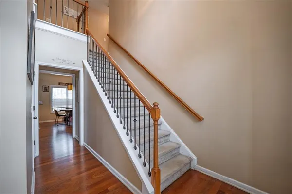 a view of staircase with railing and white walls