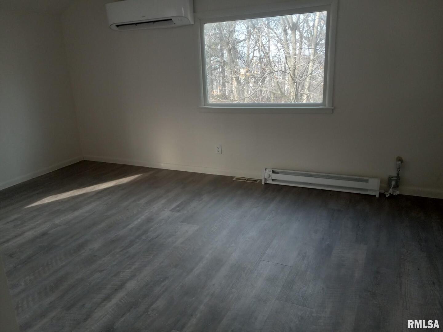 735 20th Avenue, Unit 8 East Moline, IL 61244 - Photo 2 of 5 an empty room with wooden floor and windows