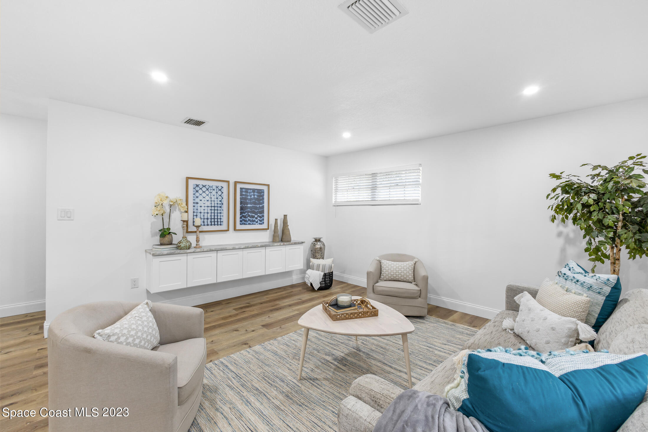2300 Cox Road Cocoa, FL 32926 - Photo 11 of 41 a living room with furniture and a potted plant