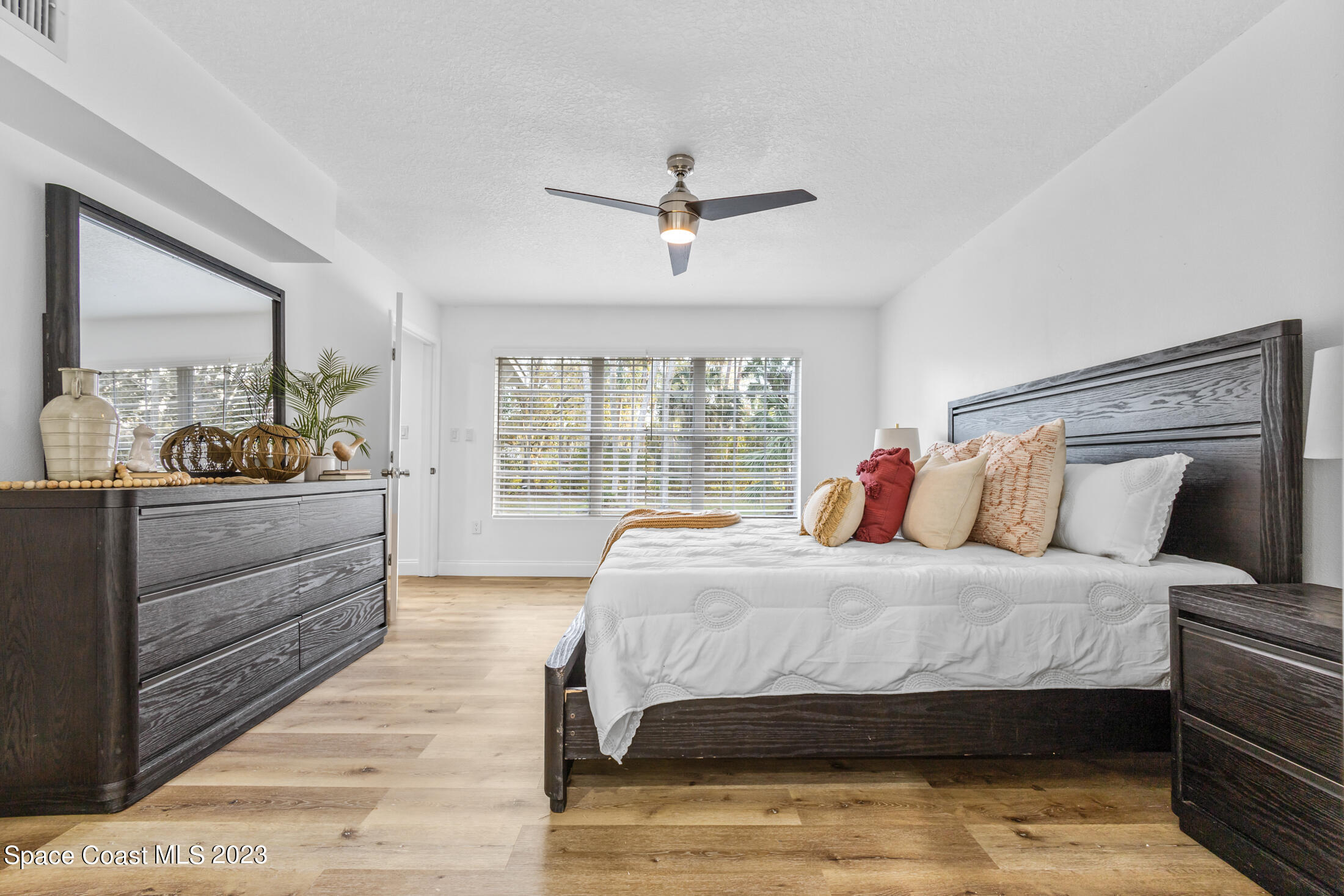2300 Cox Road Cocoa, FL 32926 - Photo 14 of 41 a bedroom with a large bed mirror and a window