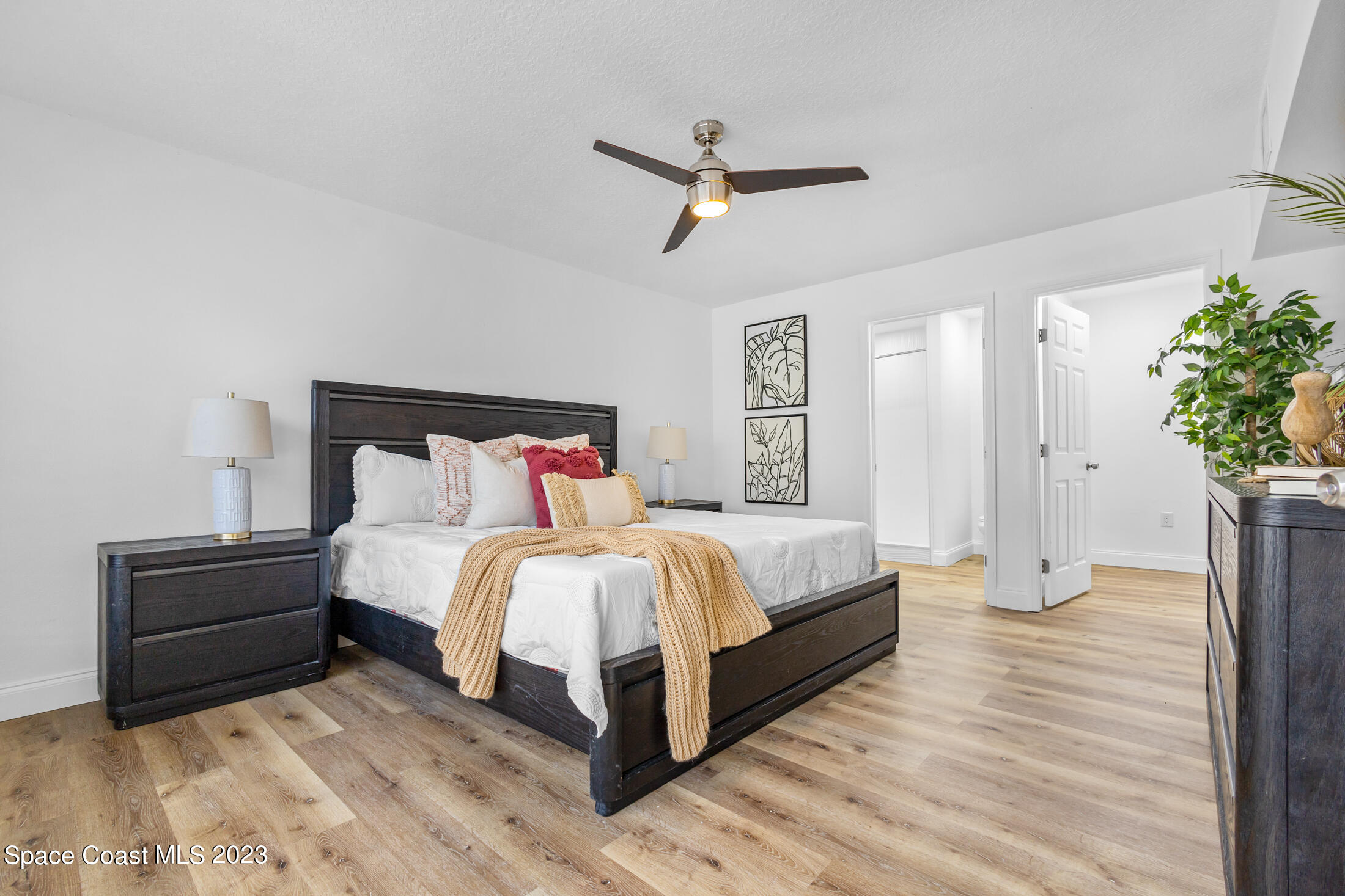 2300 Cox Road Cocoa, FL 32926 - Photo 15 of 41 a spacious bedroom with a bed and a potted plant