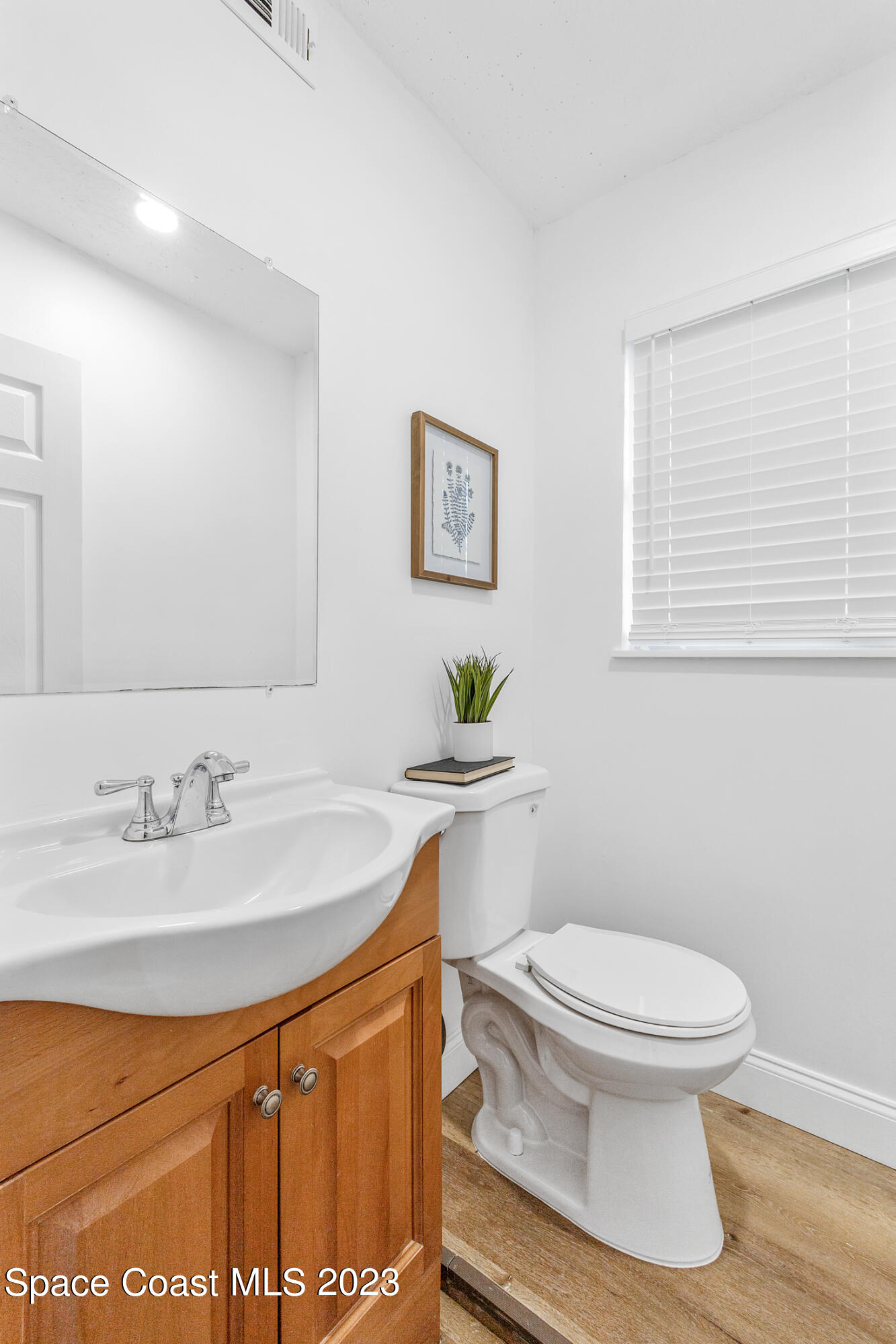 2300 Cox Road Cocoa, FL 32926 - Photo 17 of 41 a bathroom with a sink toilet and a mirror