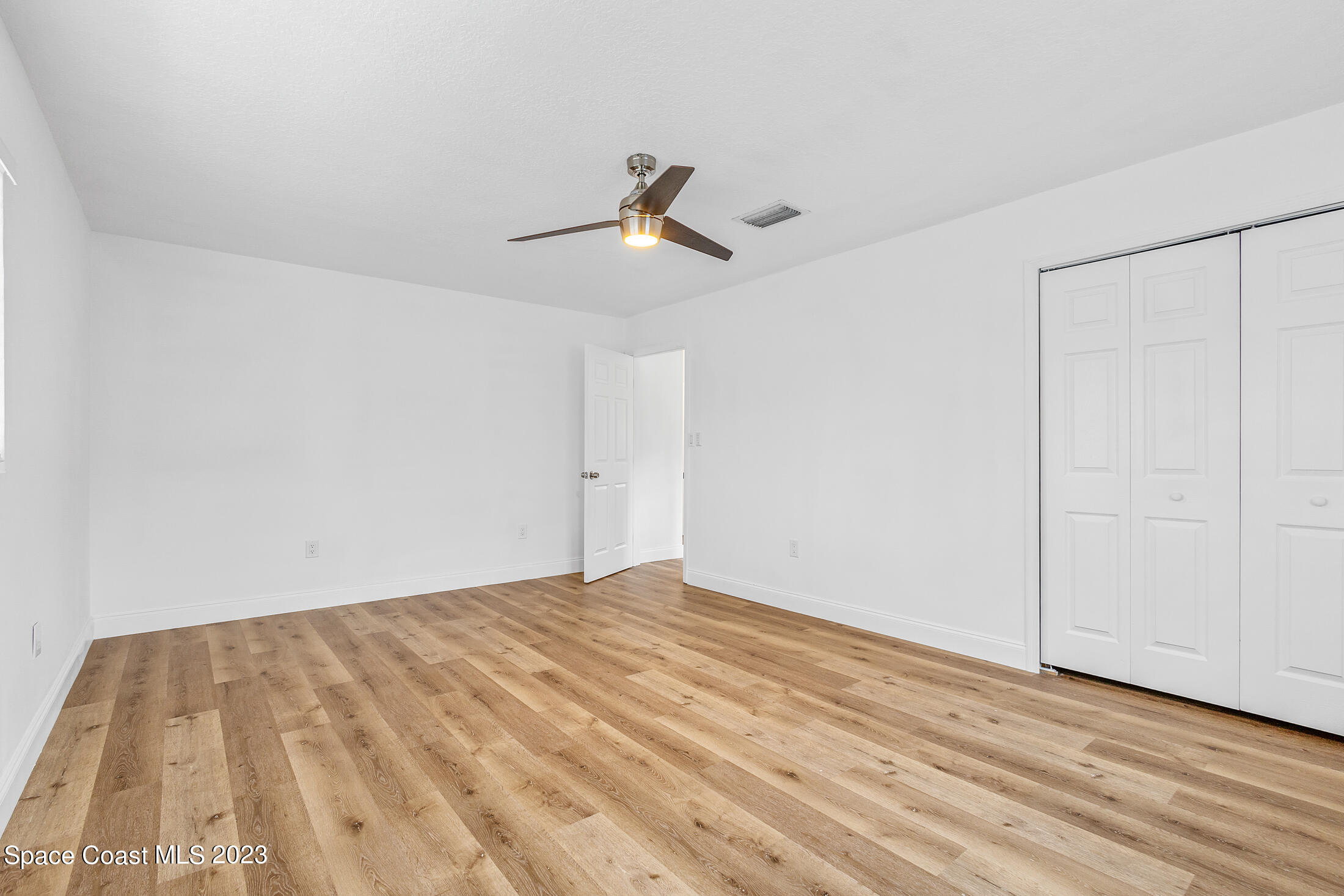 2300 Cox Road Cocoa, FL 32926 - Photo 21 of 41 a view of empty room with wooden floor