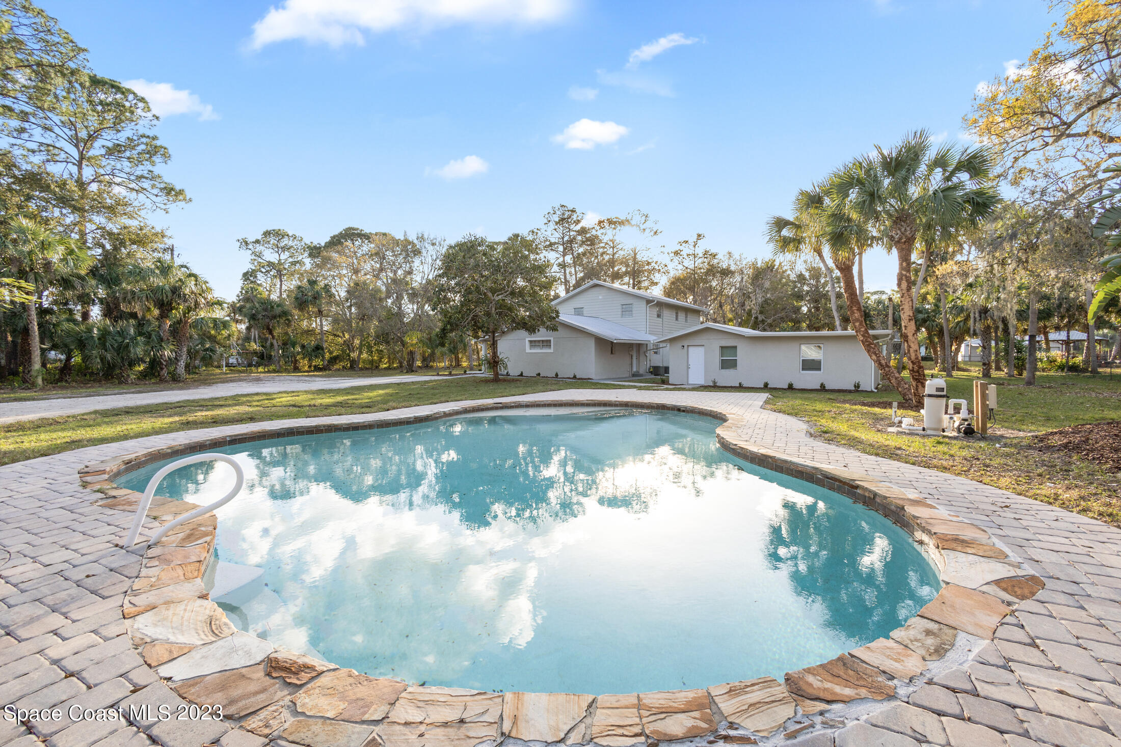 2300 Cox Road Cocoa, FL 32926 - Photo 31 of 41 a view of a swimming pool with a yard
