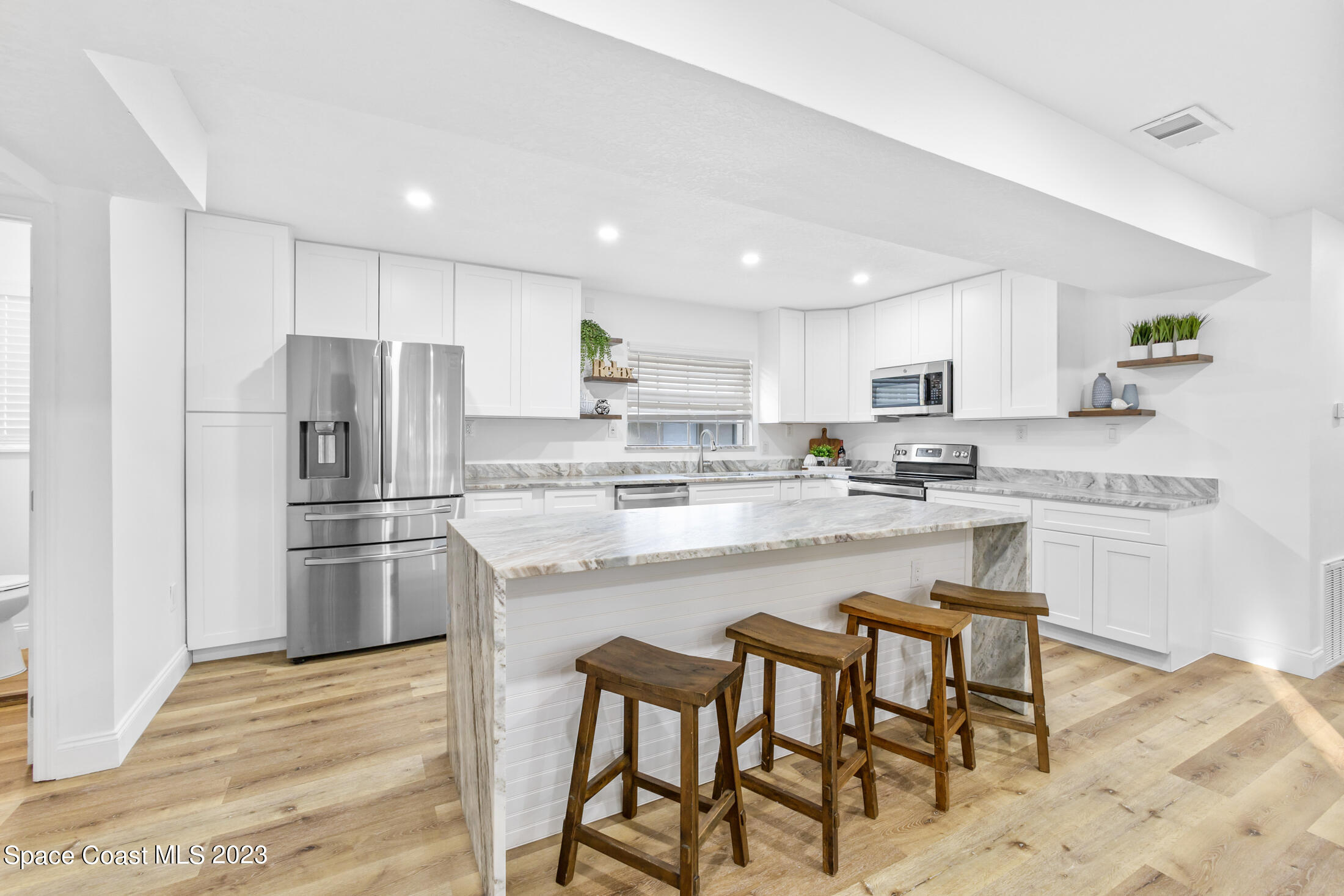 2300 Cox Road Cocoa, FL 32926 - Photo 6 of 41 a kitchen with stainless steel appliances granite countertop a refrigerator and microwave