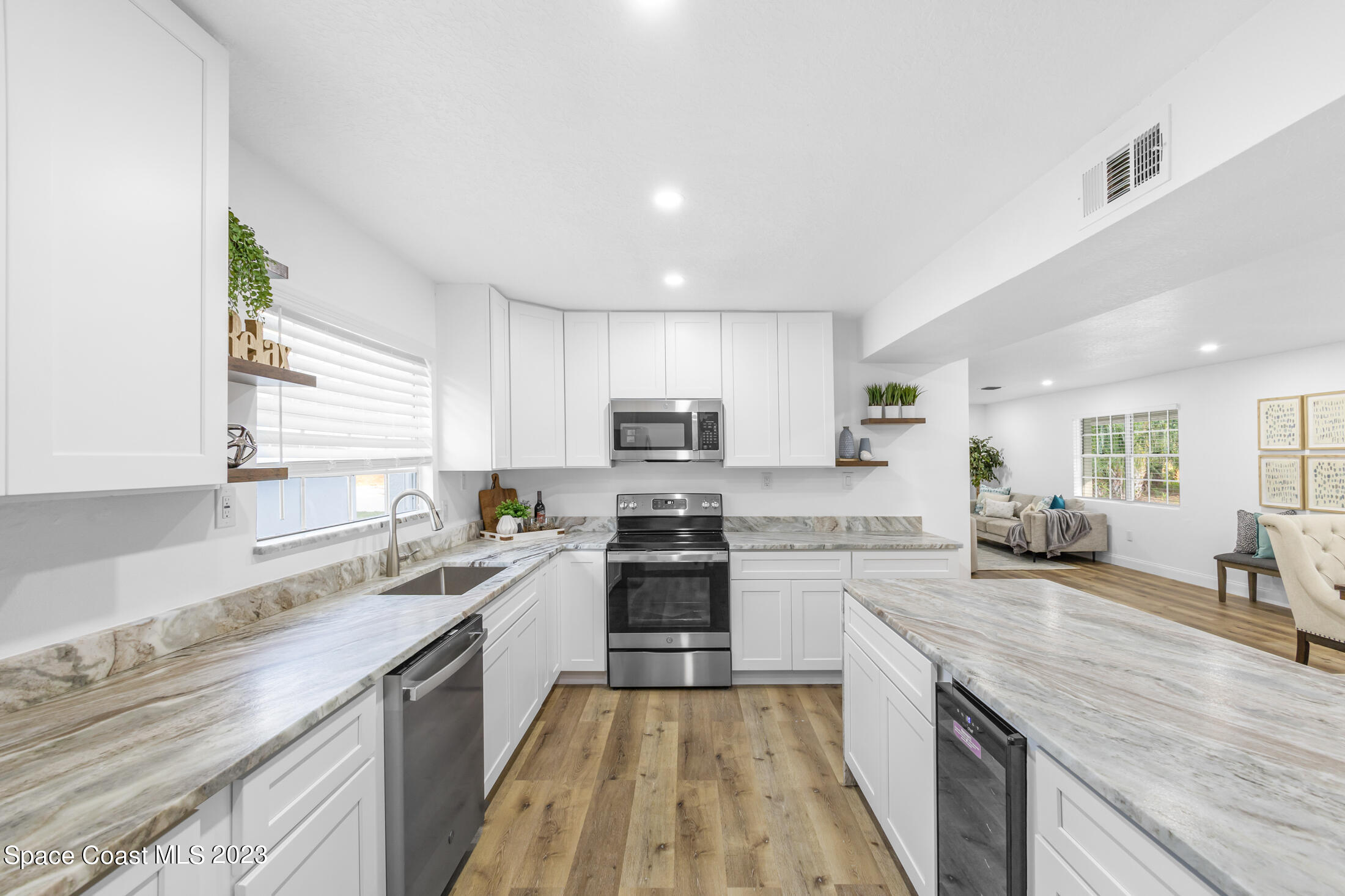 2300 Cox Road Cocoa, FL 32926 - Photo 9 of 41 a large kitchen with a stove top oven a sink a counter space and cabinets