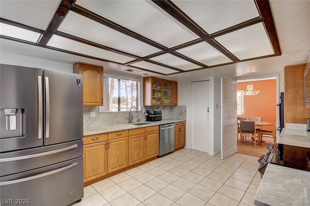 1401 Sharon Road Las Vegas, NV 89106 - Photo 40 of 73 Tiled flooring and warm wood cabinetry define this functional culinary space.