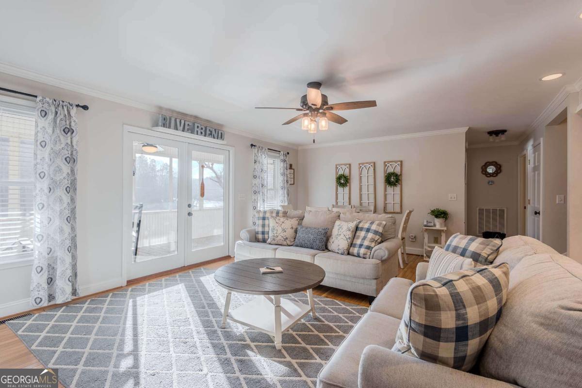 53 Addle Trail, Unit 2382 Ellijay, GA 30540 - Photo 14 of 42 a living room with furniture and a floor to ceiling window