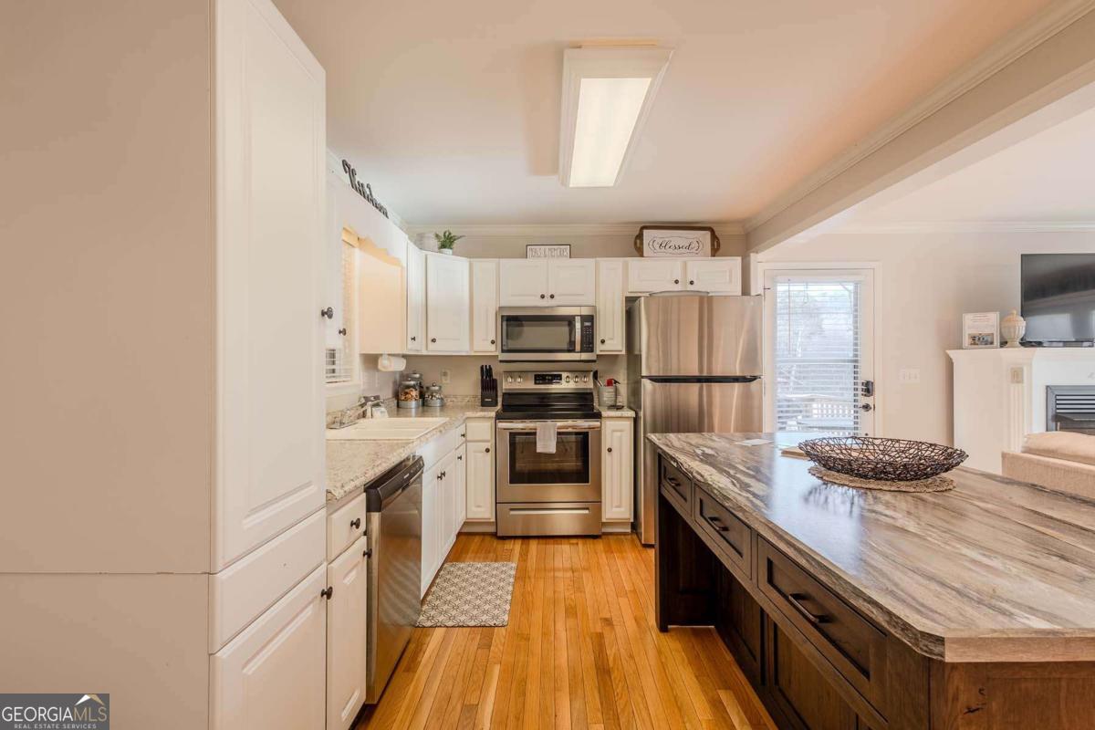 53 Addle Trail, Unit 2382 Ellijay, GA 30540 - Photo 17 of 42 a kitchen with kitchen island granite countertop lots of counter top space and stainless steel appliances