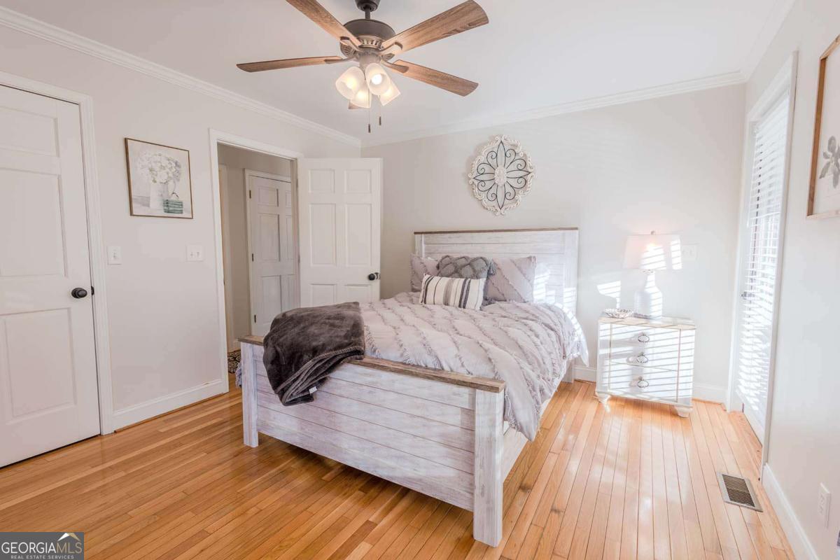 53 Addle Trail, Unit 2382 Ellijay, GA 30540 - Photo 18 of 42 a bedroom with a bed and wooden floor